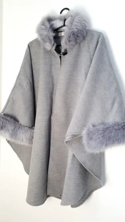Outlet poncho with a faux fur trim on the hood and cuffs.