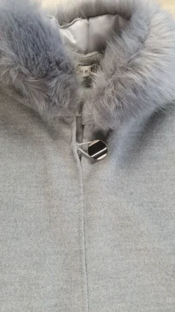 Outlet poncho with a faux fur trim on the hood and cuffs.