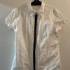 Hot ORSAY White shirt with little ribbons.